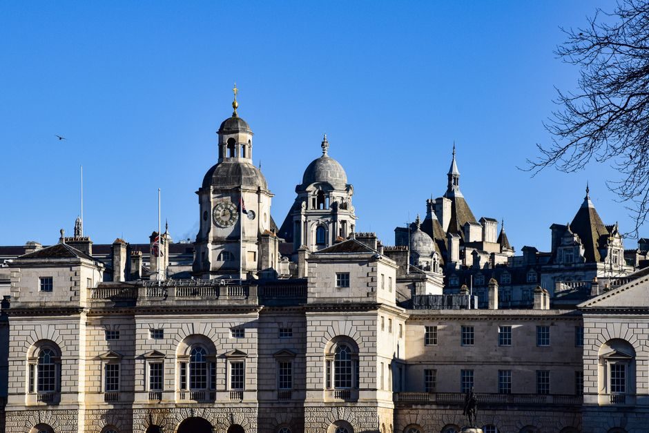 A classic view of the iconic Horse Guards Building in London under a clear blue sky.