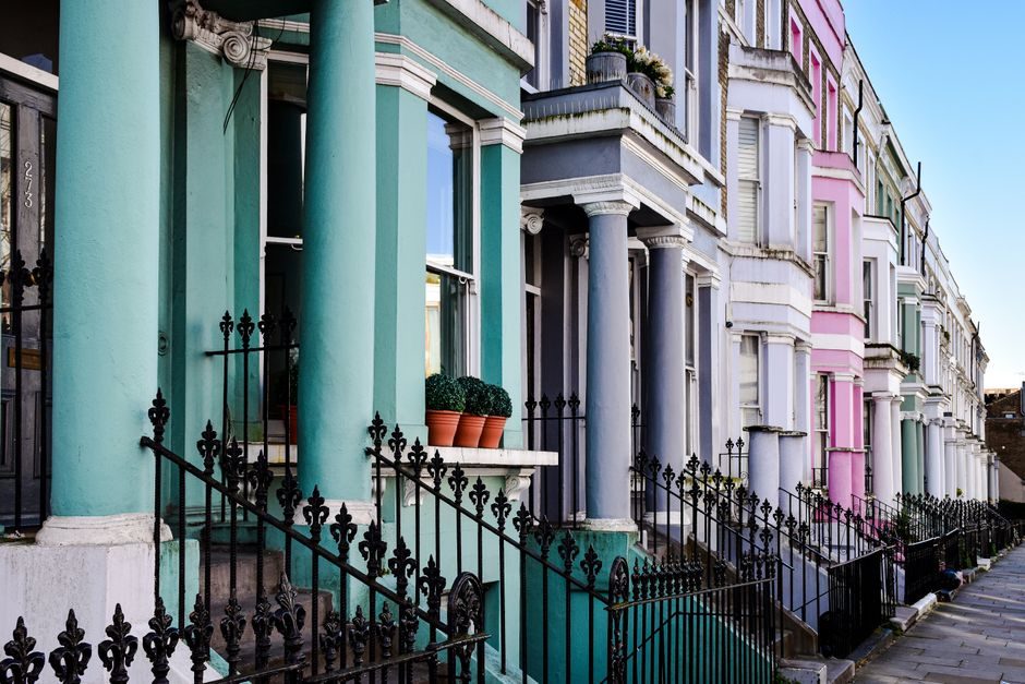 Vibrant row of colorful houses in Notting Hill, London.