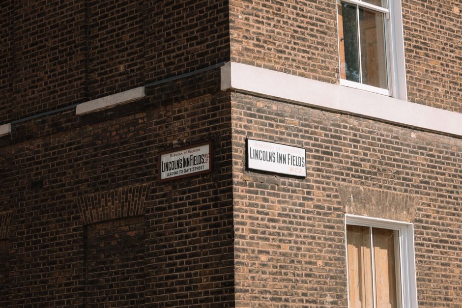 Close-up of a brick building with street signs in London, UK.