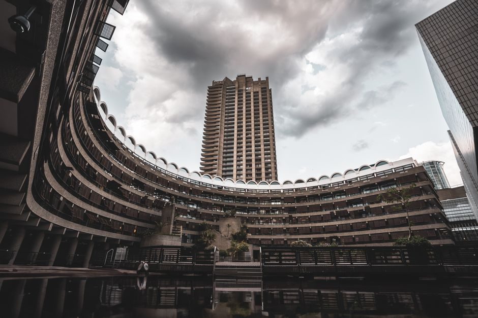 A striking view of the Barbican Centre's unique architecture in London, UK under dramatic skies.