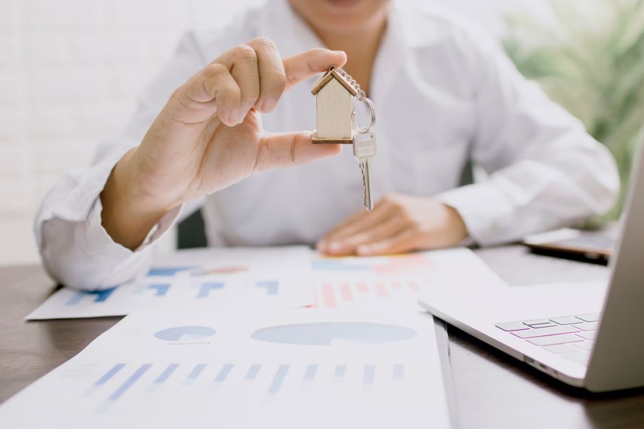 A landlord signing buy-to-let mortgage paperwork at a desk