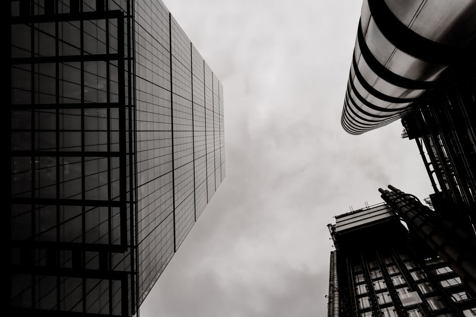 Low angle view of modern skyscrapers in London, showcasing architectural beauty in black-and-white.