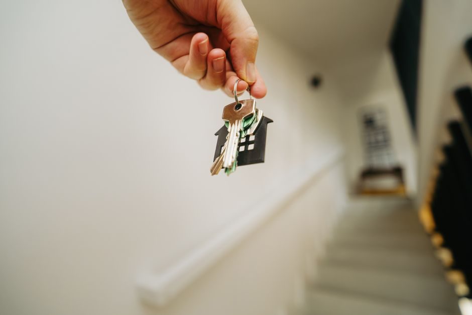 A student collecting the keys to a new flat in London, representing a parent-funded purchase