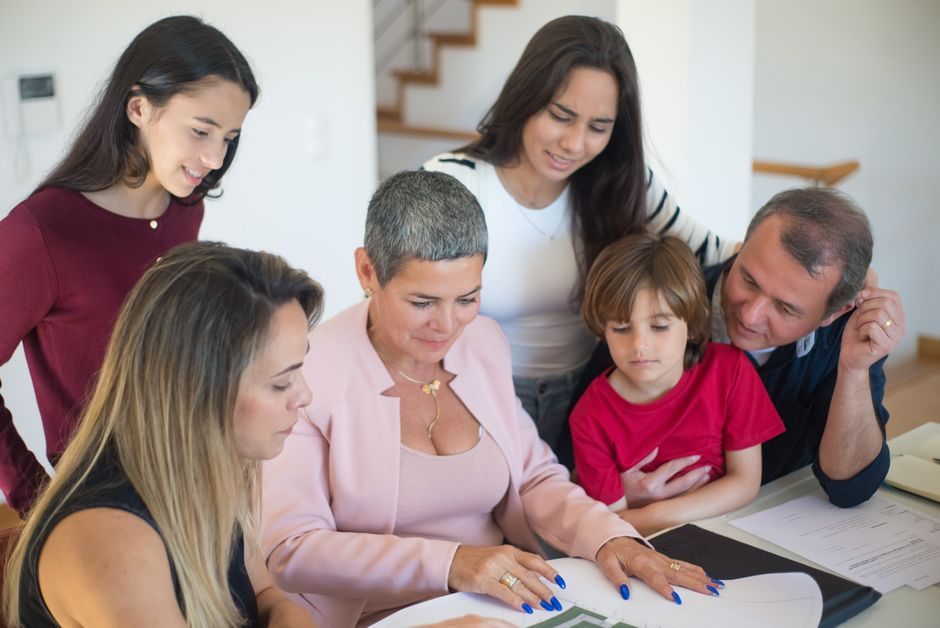 An overseas parent and adult student child reviewing UK property purchase documents together