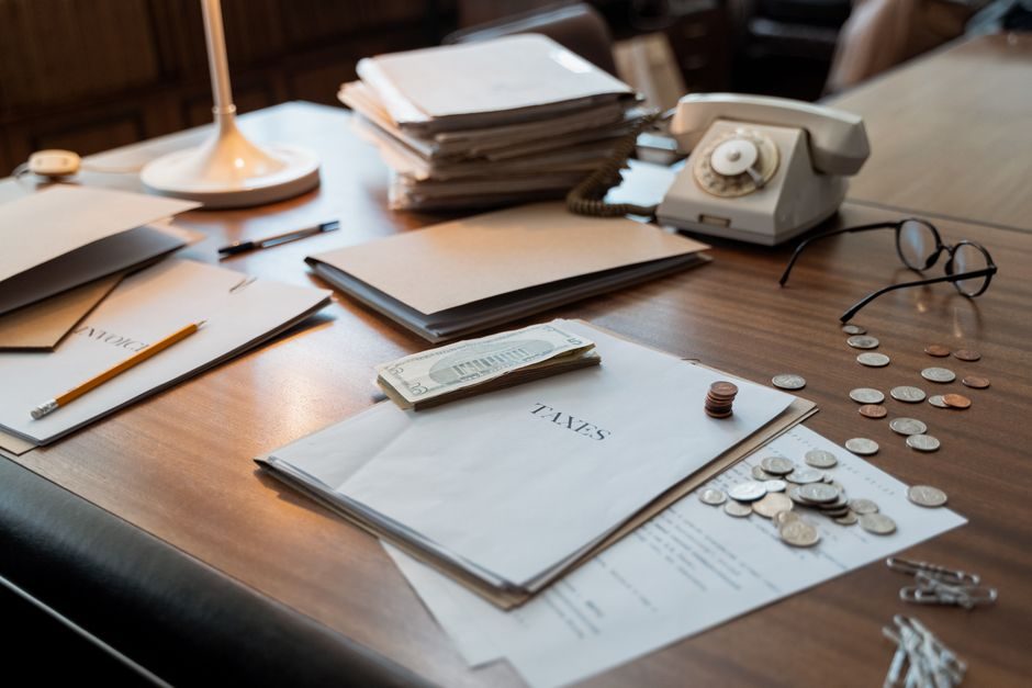 Tax documents and a calculator laid out on a desk — planning UK rental income tax