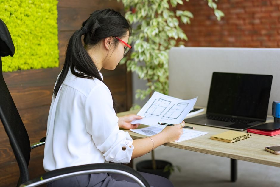 An overseas investor reviewing UK property tax planning documents on a laptop