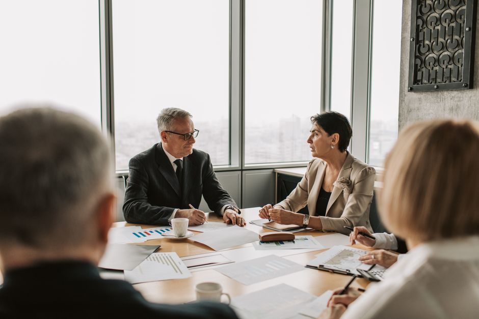 Residents in a London flat building discussing management decisions as co-freeholders