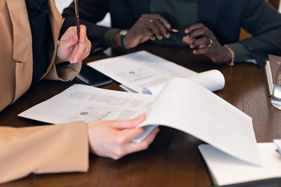 Mortgage application documents and pen on a desk, representing UK lending paperwork