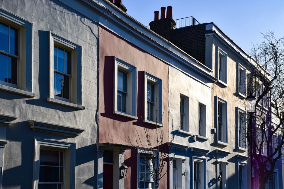 A residential street in London showing a mix of property types