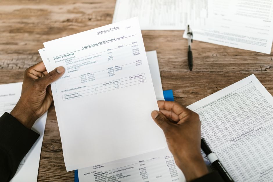 A person reviewing UK savings paperwork, planning a Lifetime ISA deposit.