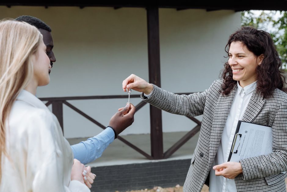A couple receiving keys to their first UK home after completing a purchase.