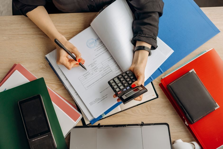 Reviewing mortgage finances on a laptop with a calculator