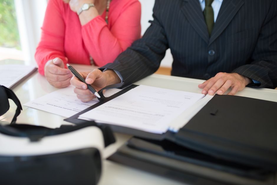 A solicitor reviewing and signing property contract documents