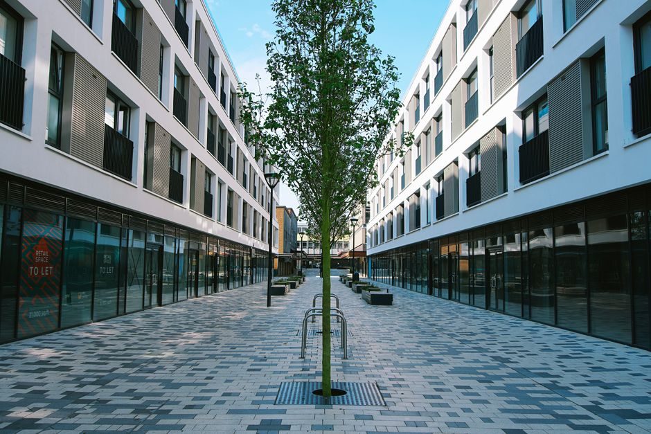 A modern UK new-build development approaching completion with construction scaffolding being removed