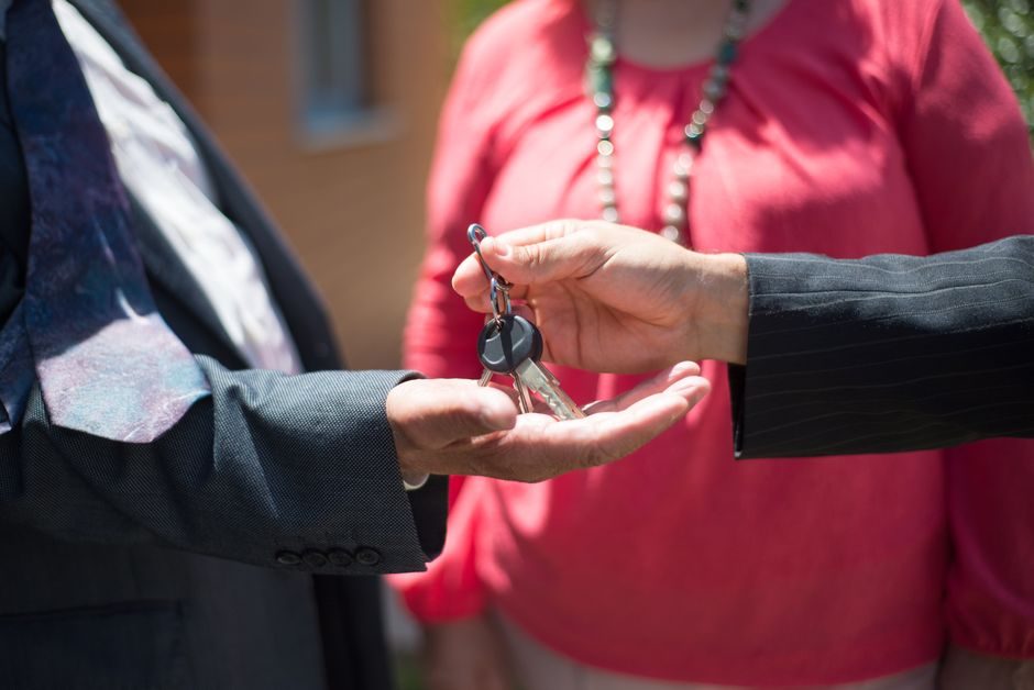A set of house keys being handed over on property completion day
