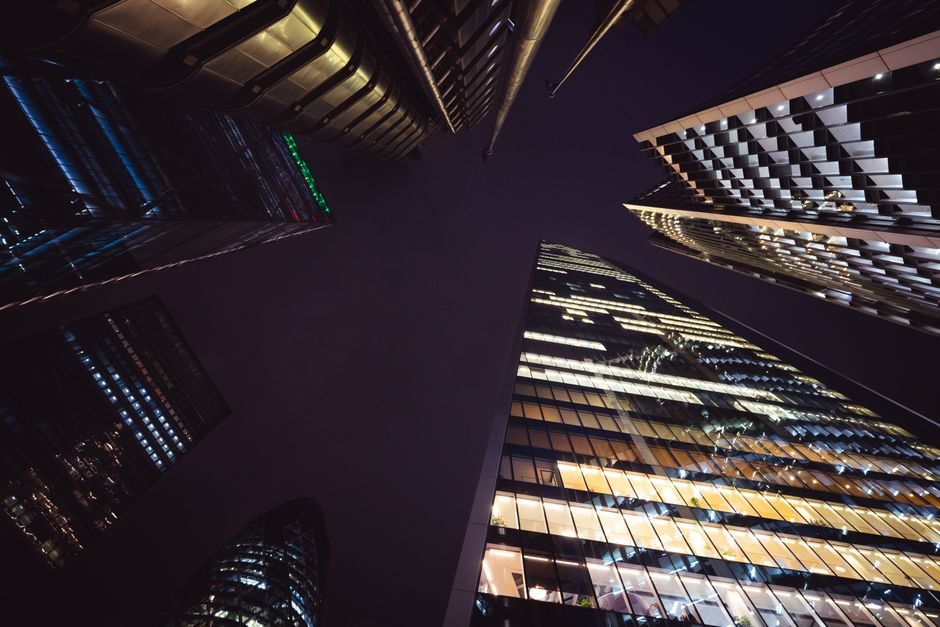 London's financial district at dusk — a market holding steady amid elevated construction-sector stress and a paused rate-cutting cycle in August 2026