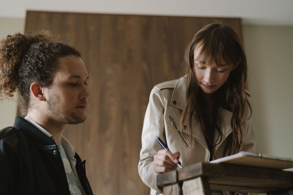 A landlord and tenant signing a residential tenancy agreement