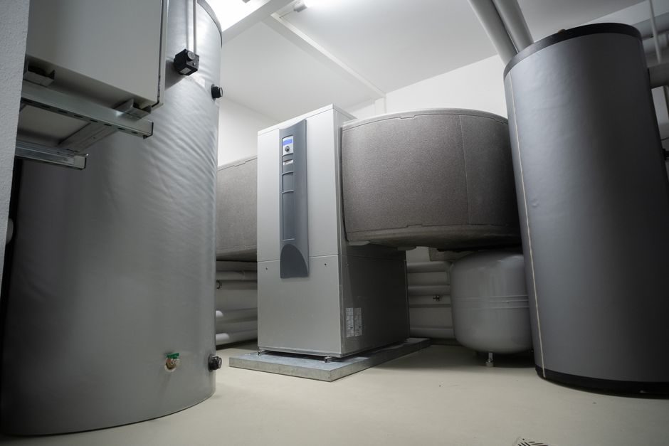 A technician installing energy-efficient heating in a UK home