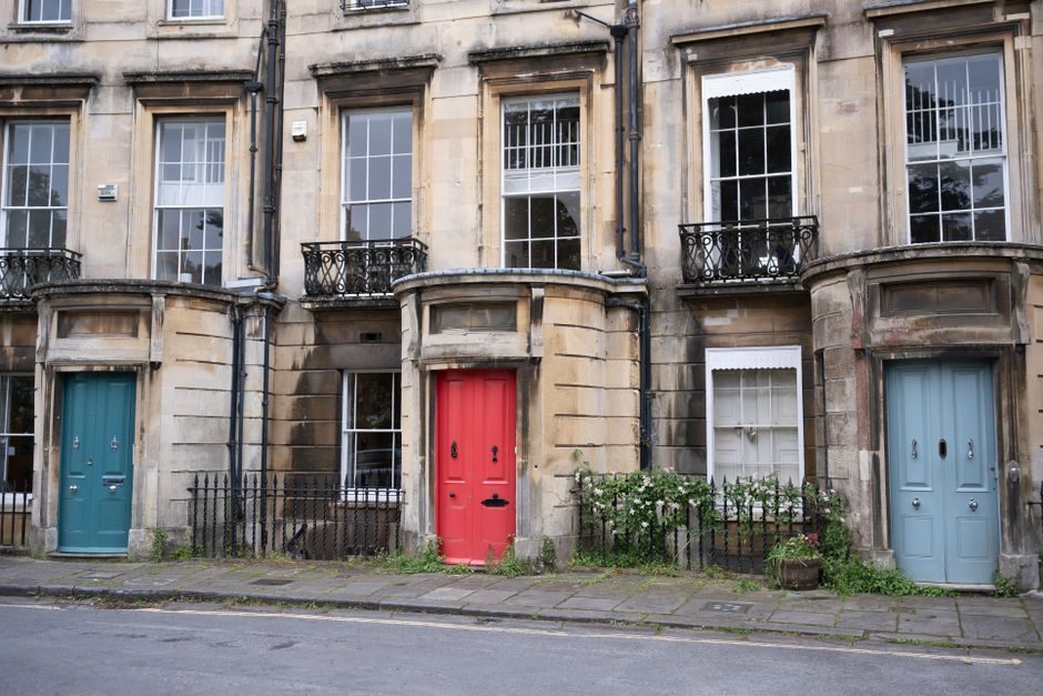Charming Georgian row houses with colorful doors in a historic neighborhood.