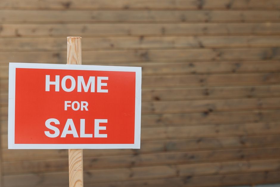 A residential street with a for-sale sign in England