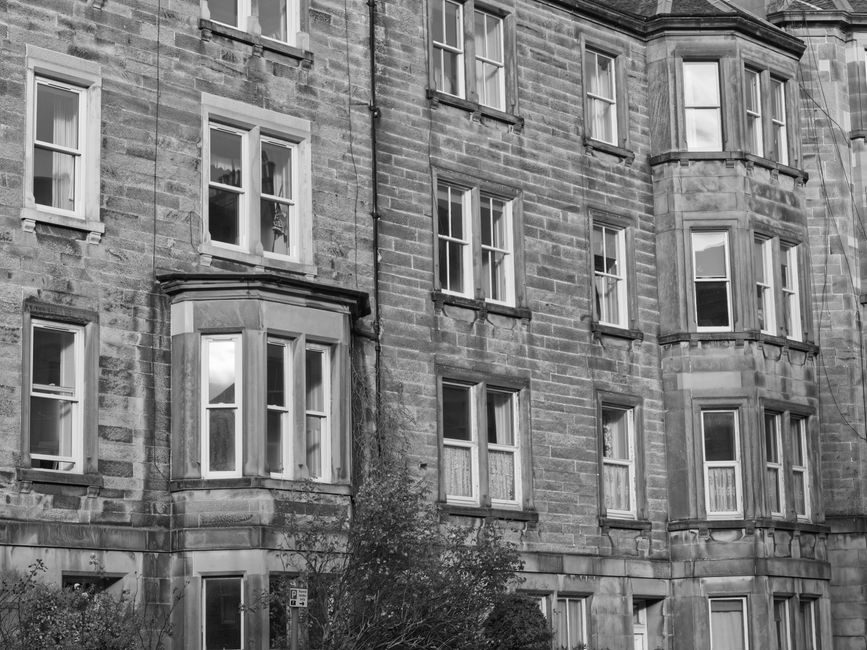 Monochrome view of a classic stone building facade in Edinburgh, Scotland.