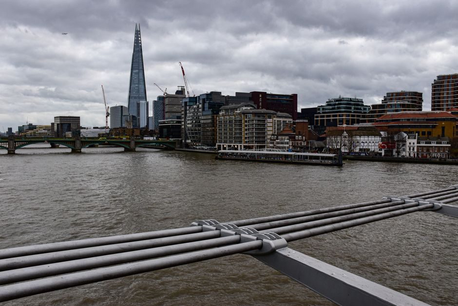 Dramatic view of London's skyline featuring The Shard and River Thames.